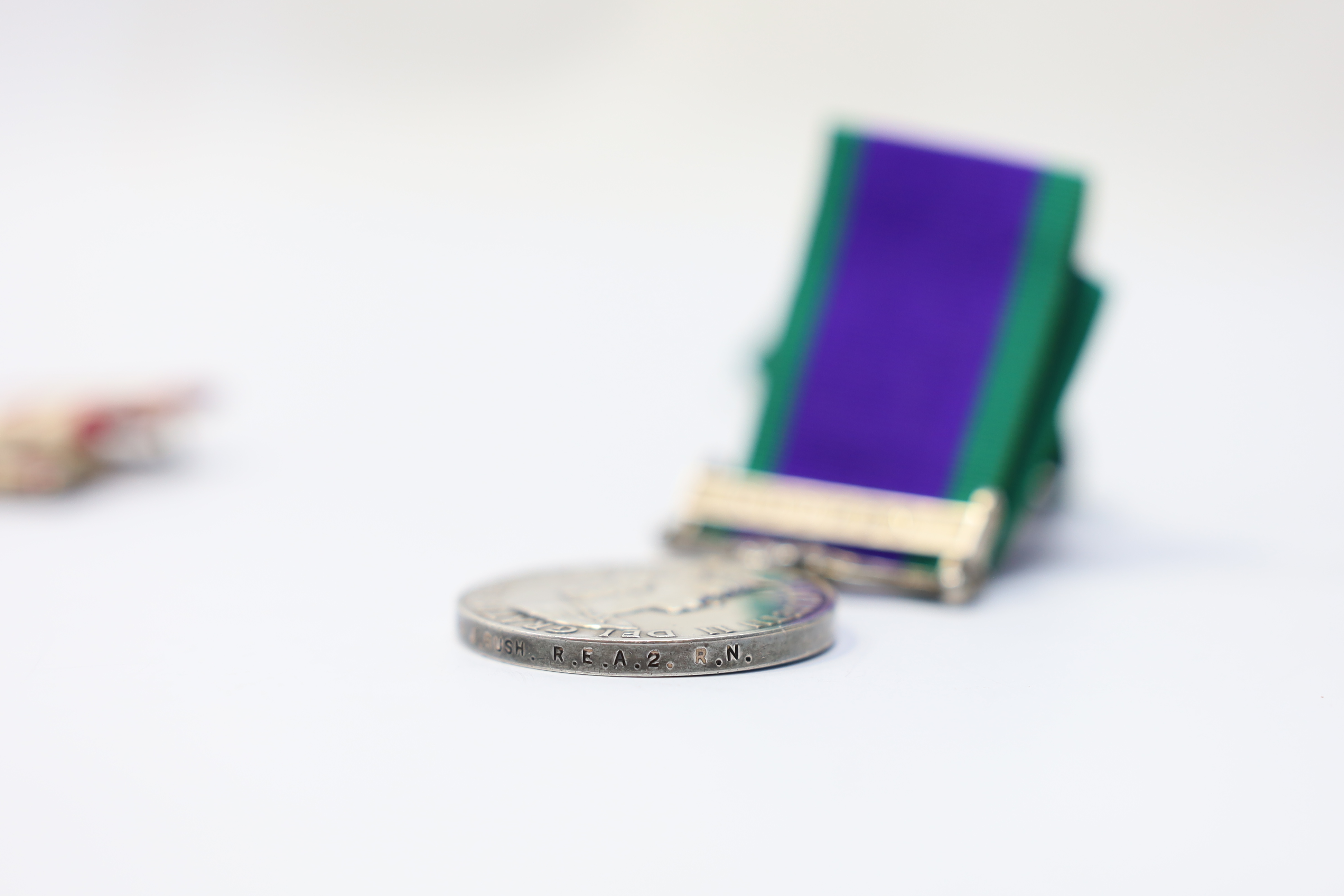 Three ERII Royal Navy medals; a Campaign Service Medal with a bar for Radfan awarded to J. Rush R.E.A.2 R.N., A Naval General Service Medal with a bar for the near East awarded to P/SKX J-C. Shaw M.(E.)1. R.N., plus a se